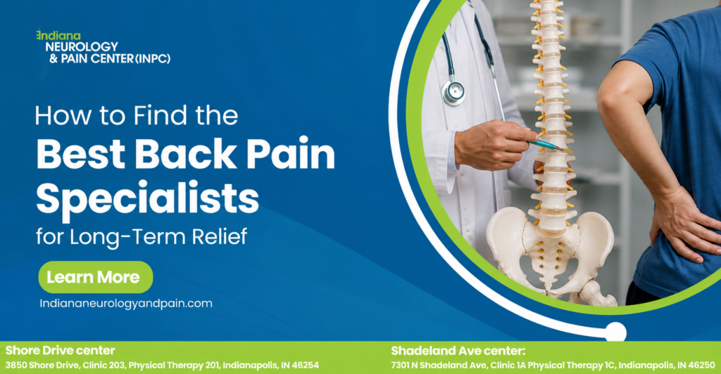Doctor explaining a spine model to a patient in a blue shirt holding their lower back, representing how to find the best back pain specialists for long-term relief.